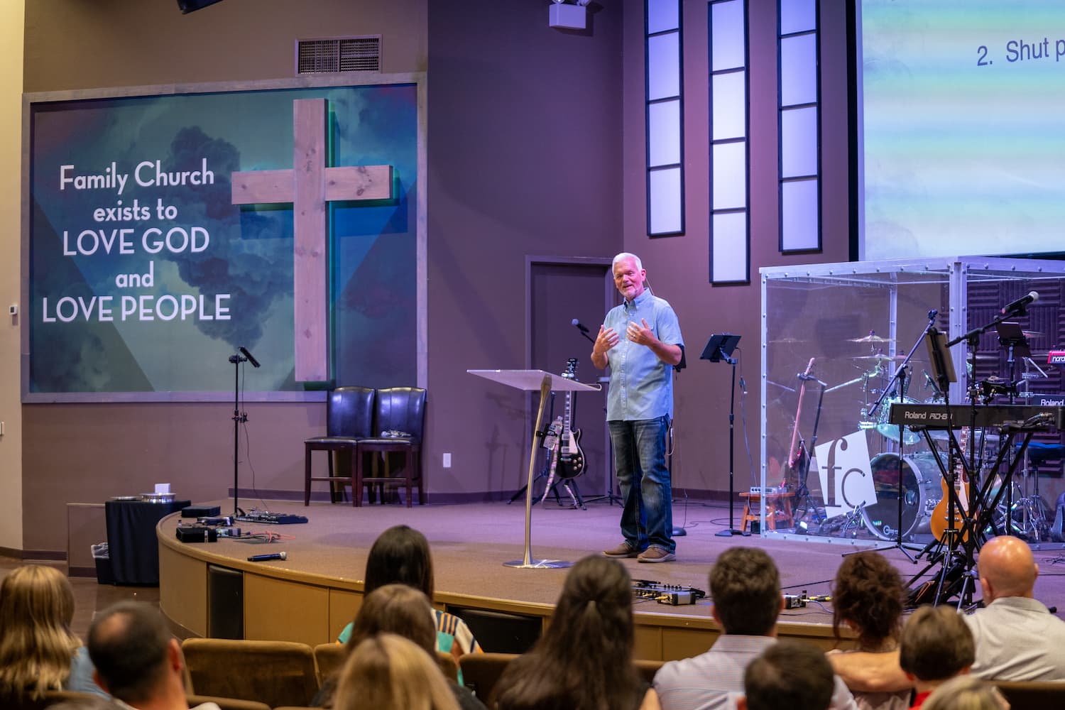 Redfield pastor preaching on stage during sunday service